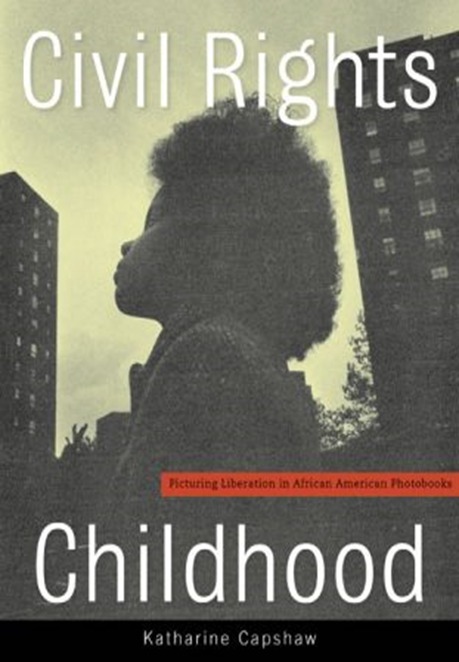 Book cover with the title "Civil Rights Childhood" by Katharine Capshaw. It features a silhouette of a young African American child against a backdrop of high-rise buildings, with a subtitle "Picturing Liberation in African American Photobooks".