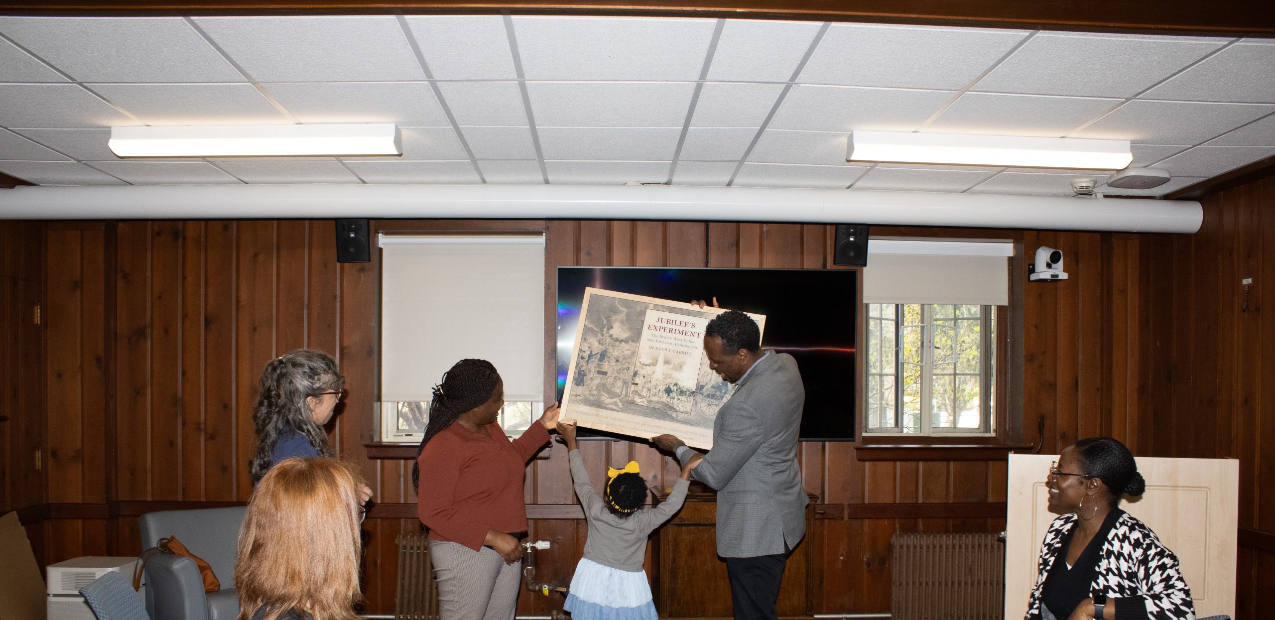 Professor Gabriel receiving his cover book in a frame