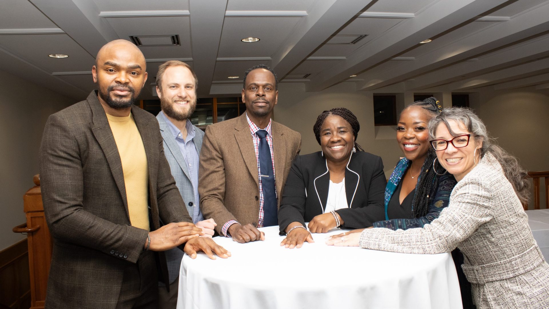 Group photo of Africana Studies Faculty at a table. (Candi Nwakasi, Joshua Mayer, Dexter Gabriel, Fiona Vernal, Shardé Davis, Evelyn Simien) Faculty.