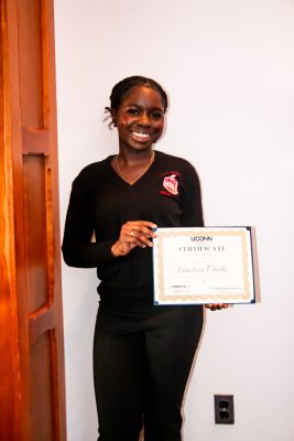 Anna Charles holding a certificate